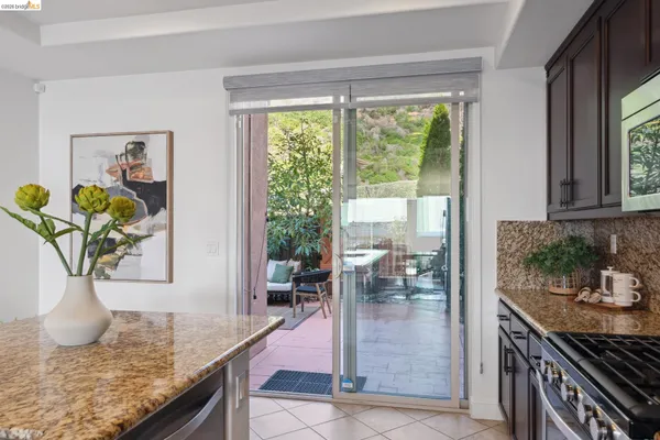 a view of living room and kitchen with granite countertop cabinets