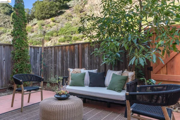 a view of a patio with table and chairs and potted plants