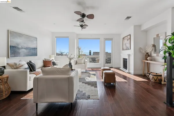 a living room with fireplace furniture and a wooden floor