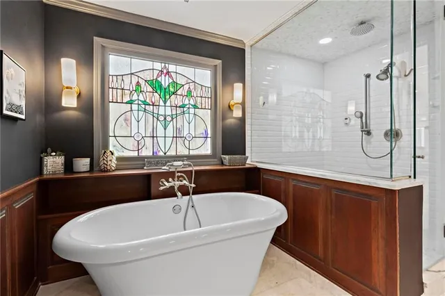 a bathroom with a tub and a shower