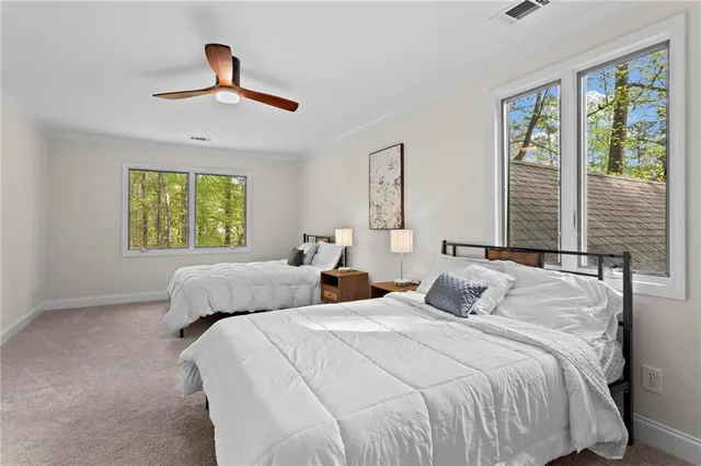 a bedroom with a large bed and a window