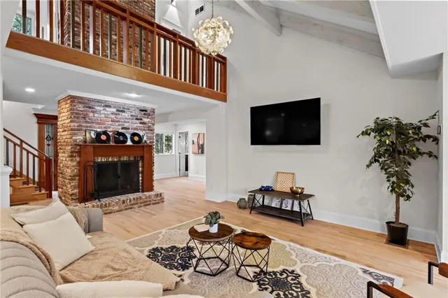 a living room with furniture a fireplace and a flat screen tv