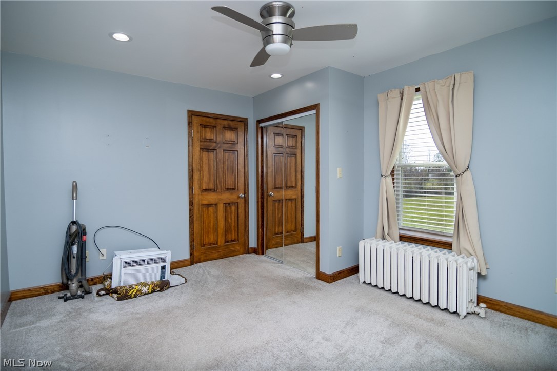 53341 Key Bellaire Road Bellaire, OH 43906 - Photo 21 of 48 Unfurnished bedroom featuring radiator, carpet floors, a closet, a ceiling fan, and recessed lighting