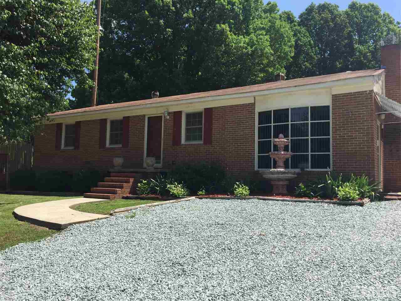 1418 Chestnut Street Roxboro, NC 27573 - Photo 1 of 7 a front view of a house with a yard