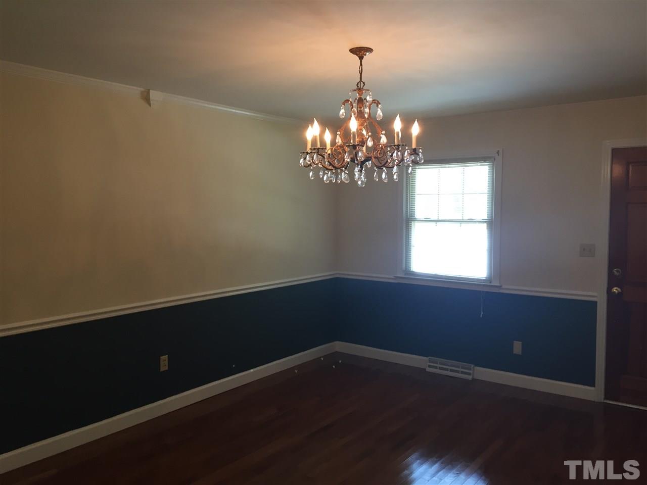 1418 Chestnut Street Roxboro, NC 27573 - Photo 5 of 7 a view of a chandelier in big room and wooden floor