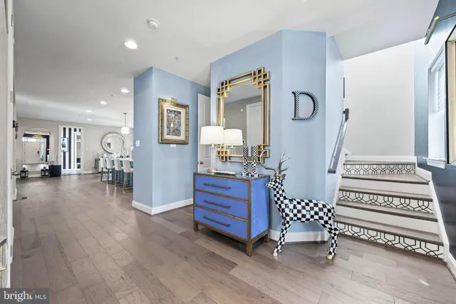 a kitchen with granite countertop a table chairs a sink dishwasher stove and cabinets with wooden floor