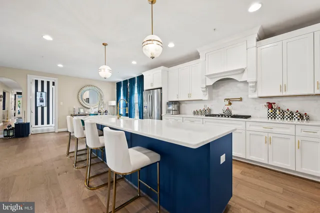 a large kitchen with stainless steel appliances kitchen island granite countertop a sink and cabinets