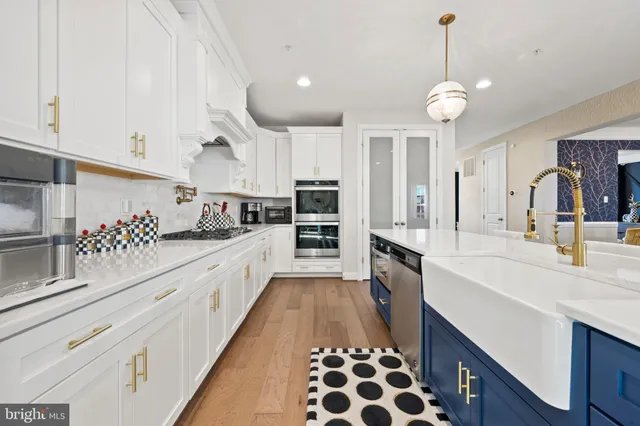 a large kitchen with kitchen island a sink stainless steel appliances and cabinets