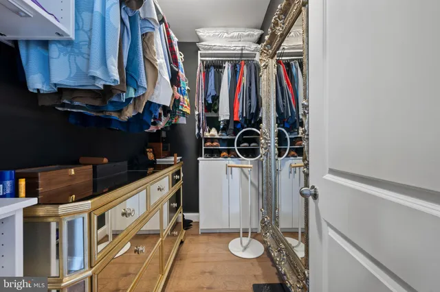 a spacious bathroom with a bathtub a double vanity sink and mirror