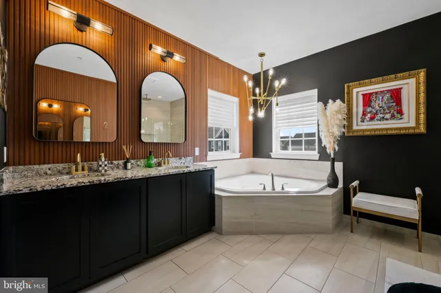a bathroom with a tub sink and mirror