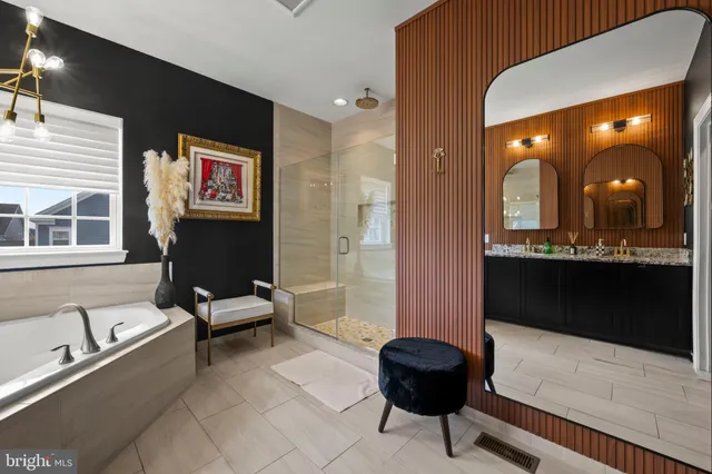 a bedroom with a bed and dresser with mirror