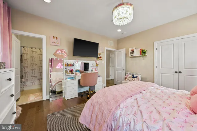 a bed room with a bed and a television