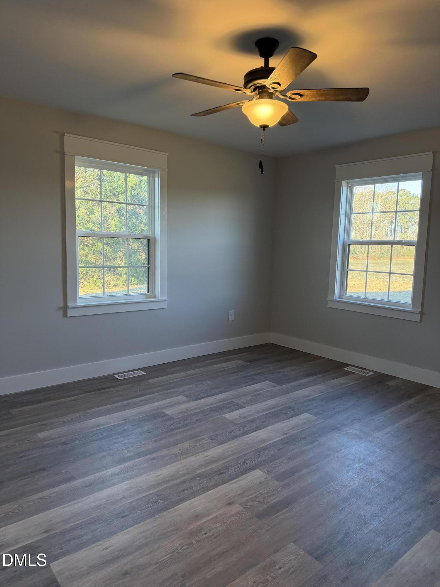 3055 Autry Mill Road Godwin, NC 28344 - Photo 18 of 21 a view of an empty room with window and wooden floor