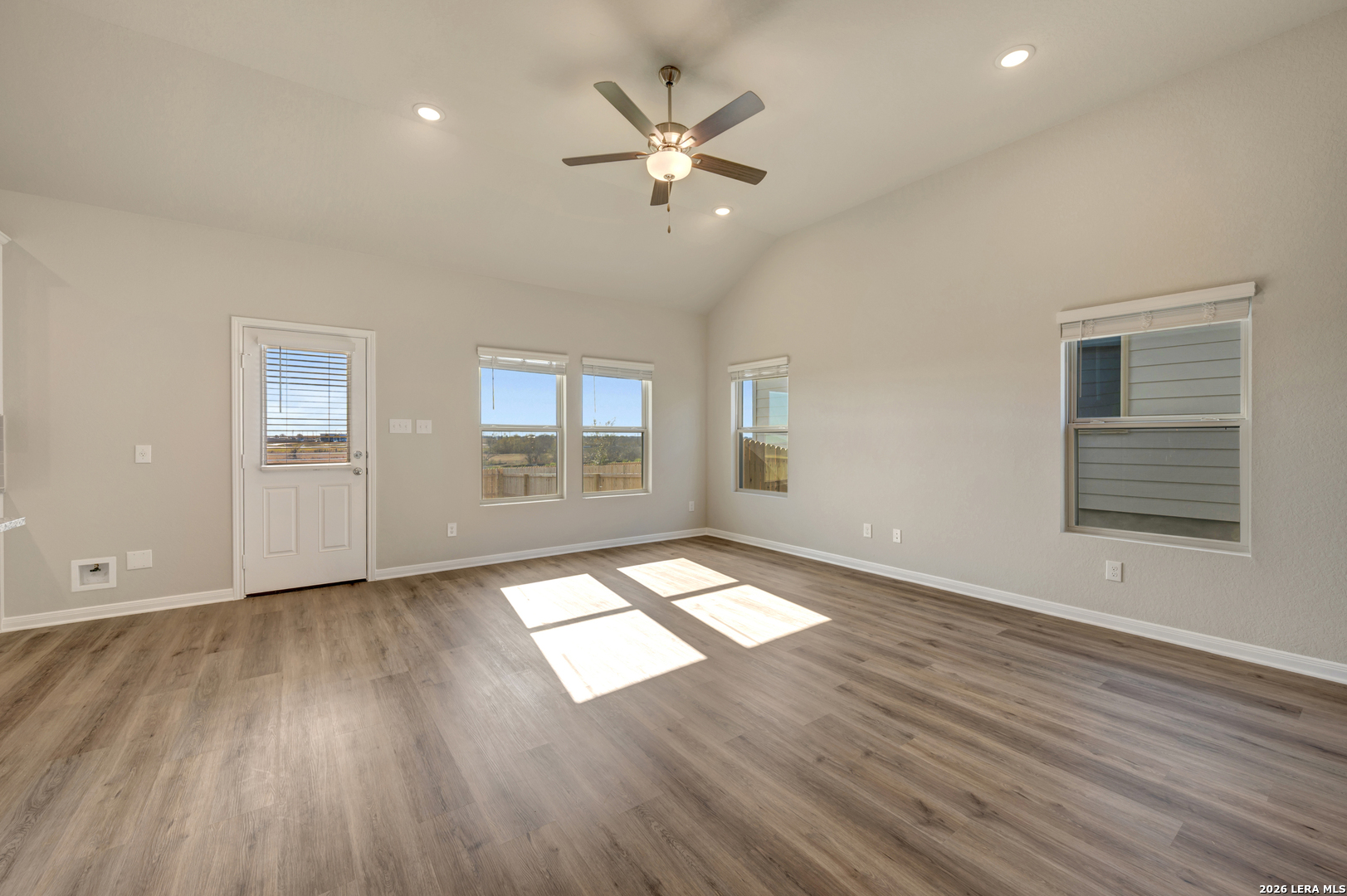 10330 Goodison Drive Converse, TX 78109 - Photo 13 of 42 a view of an empty room with wooden floor and a window