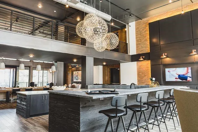 a living room with patio furniture and a floor to ceiling window