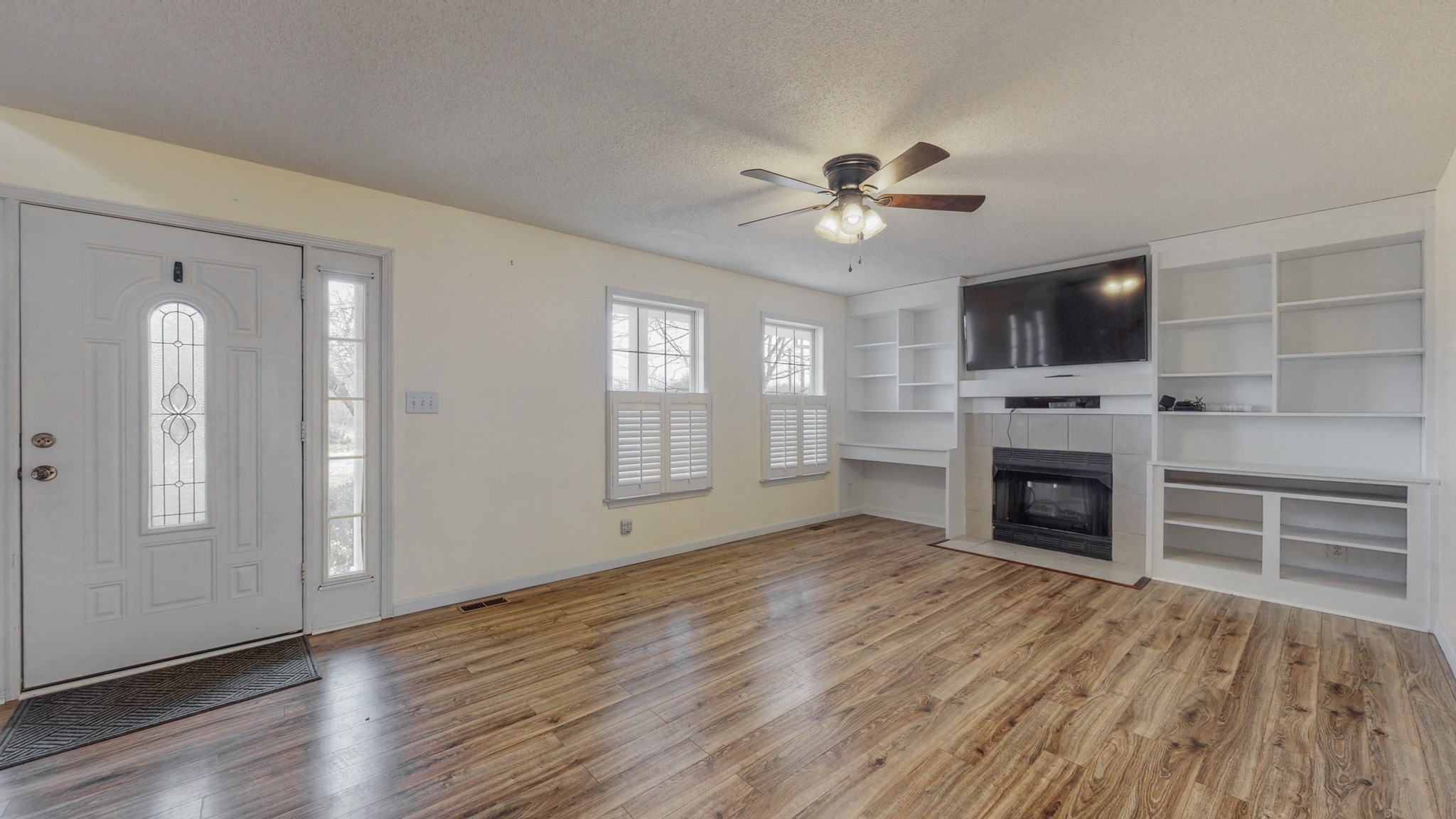 4660 Southside Road Southside, TN 37171 - Photo 22 of 48 wooden floor fireplace and windows in an empty room