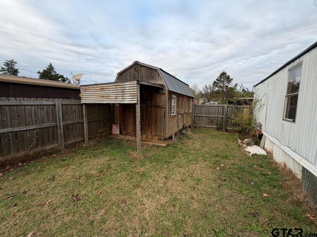 12611 Fannin Parkway Tyler, TX 75708 - Photo 14 of 15 a backyard of a house with glass top table and chairs