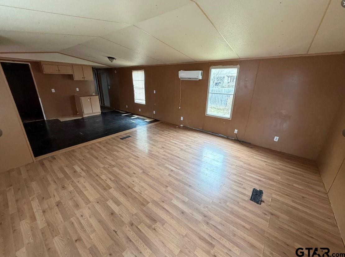 12611 Fannin Parkway Tyler, TX 75708 - Photo 5 of 15 a view of an empty room with wooden floor and a window