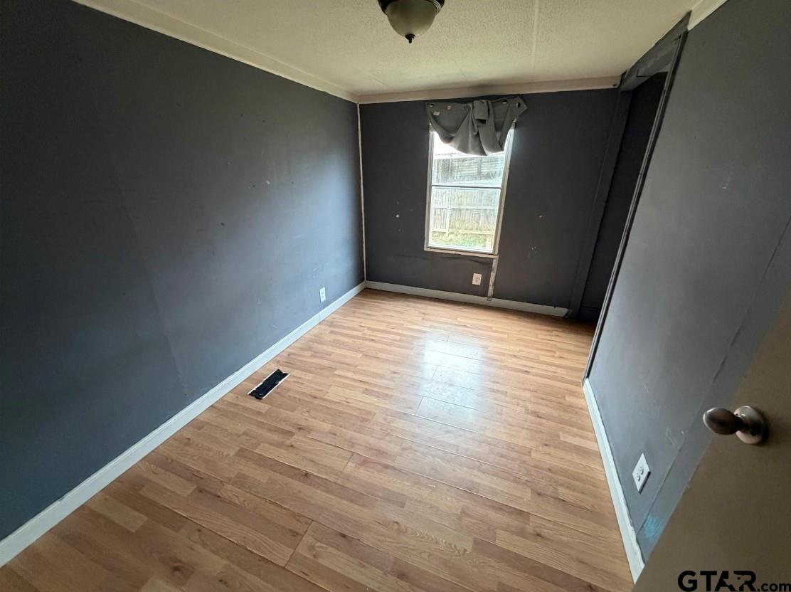 12611 Fannin Parkway Tyler, TX 75708 - Photo 7 of 15 an empty room with wooden floor and windows