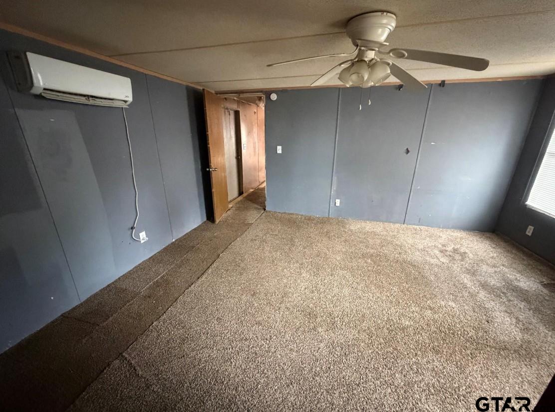 12611 Fannin Parkway Tyler, TX 75708 - Photo 8 of 15 a view of a livingroom with a chandelier fan and closet area