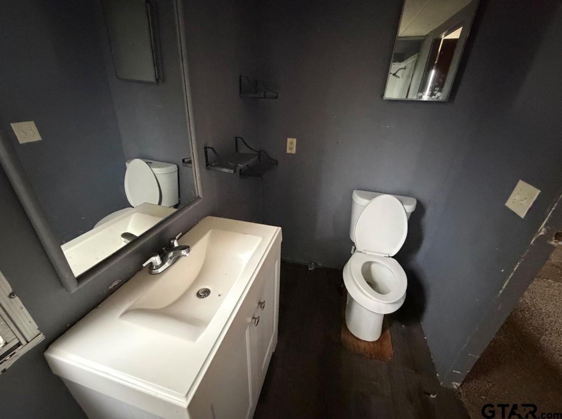 12611 Fannin Parkway Tyler, TX 75708 - Photo 10 of 15 a bathroom with a toilet sink and mirror