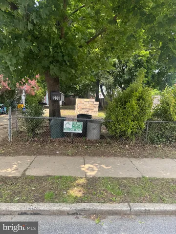 a view of a street with benches sitting next to a road