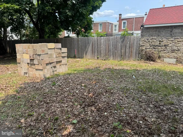 a white house that has tree in front of it