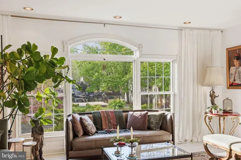 a living room with large lots of furniture and a book shelf