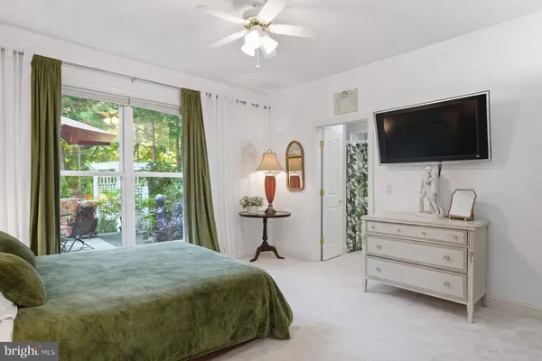a bedroom with bed and a chandelier