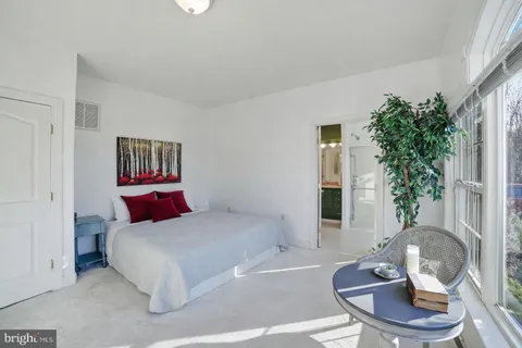 a patio with a table and chairs under an umbrella
