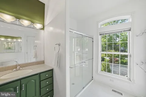 a view of a house with a tree and a yard