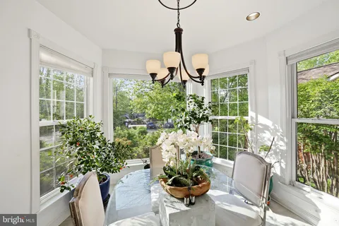 a kitchen with white cabinets and appliances