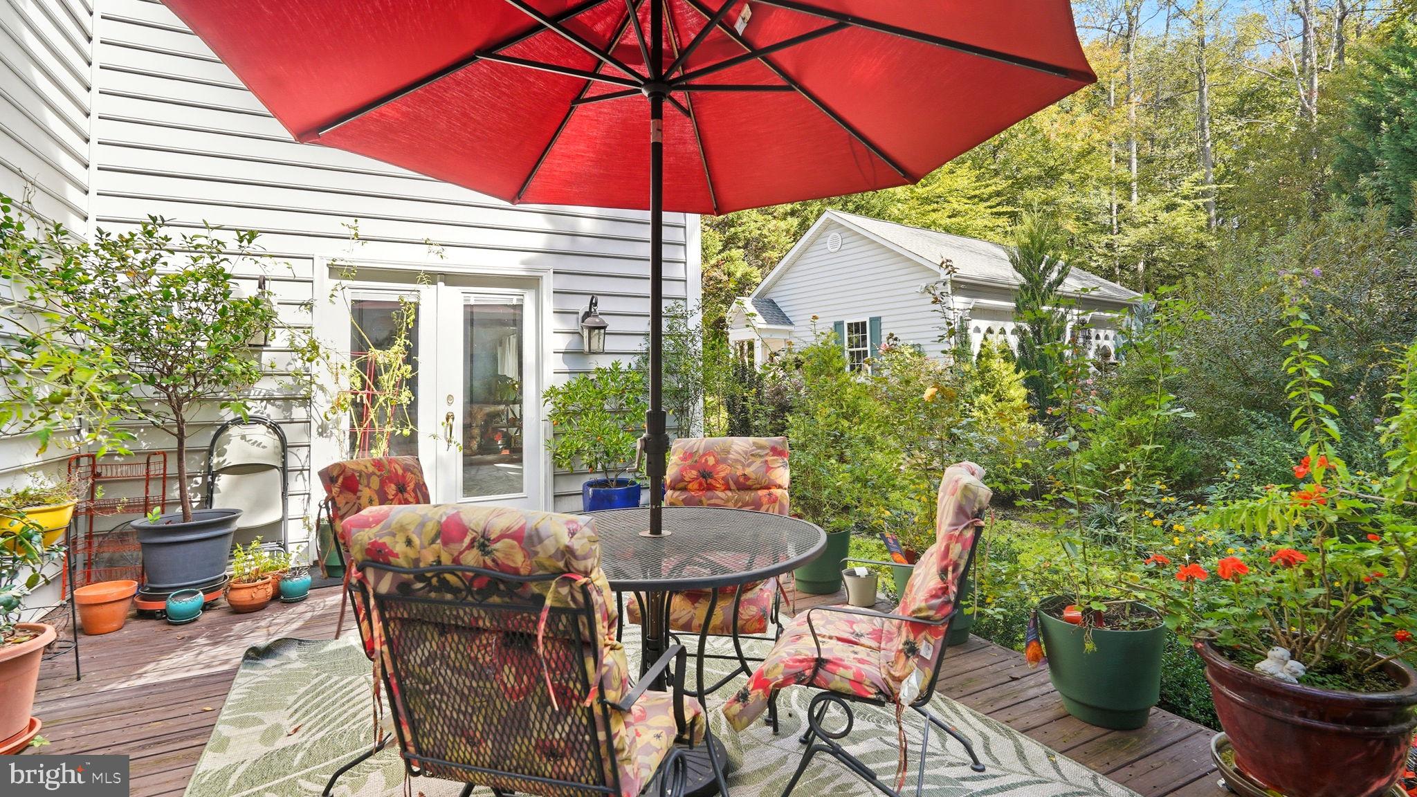 143 Edgemont Circle Locust Grove, VA 22508 - Photo 43 of 80 a patio with a table and chairs under an umbrella