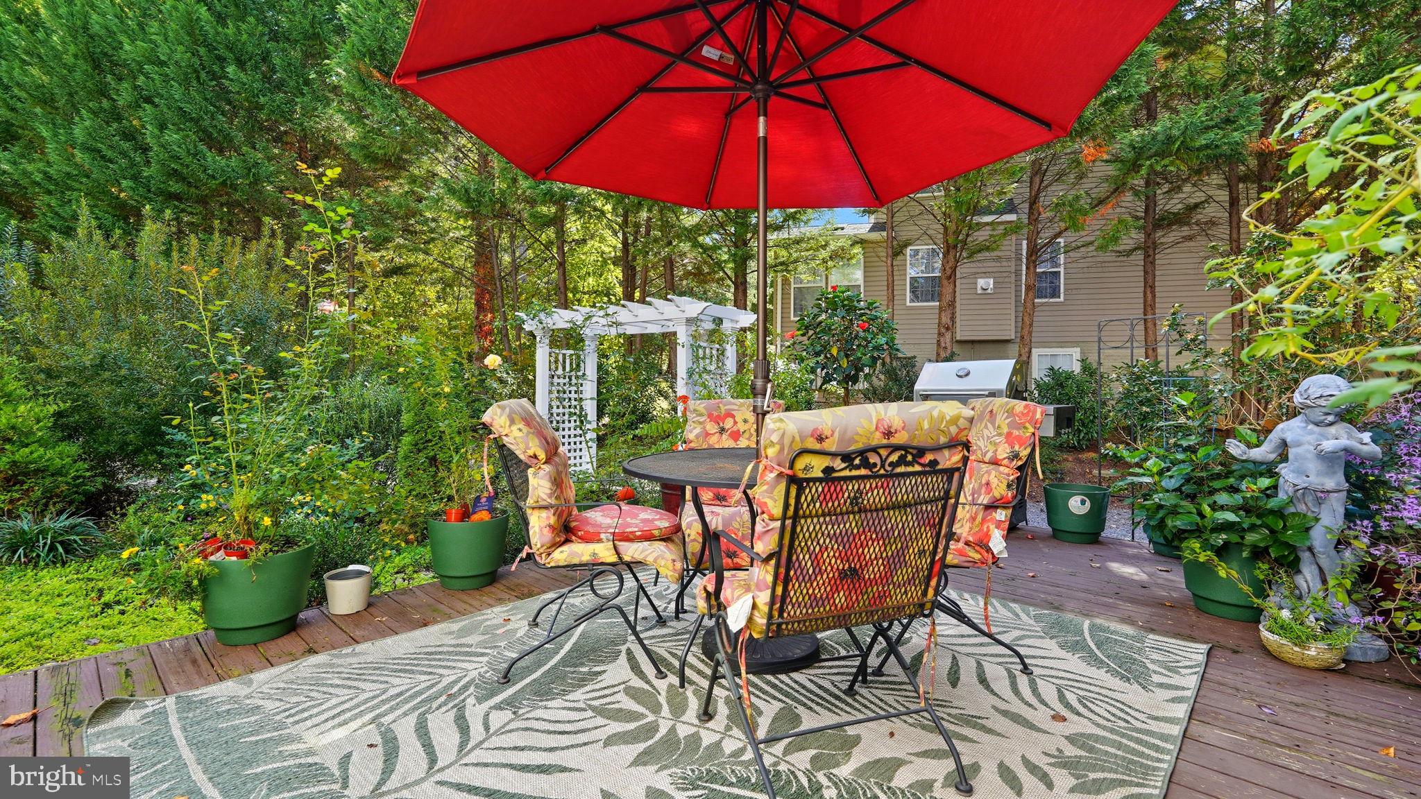 143 Edgemont Circle Locust Grove, VA 22508 - Photo 44 of 85 a patio with a table and chairs under an umbrella