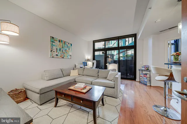 a living room with furniture and a floor to ceiling window