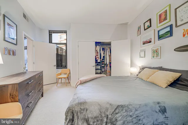 a bedroom with a bed couch and window