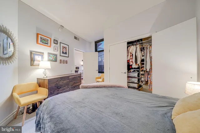 a bedroom with a bed and a chair