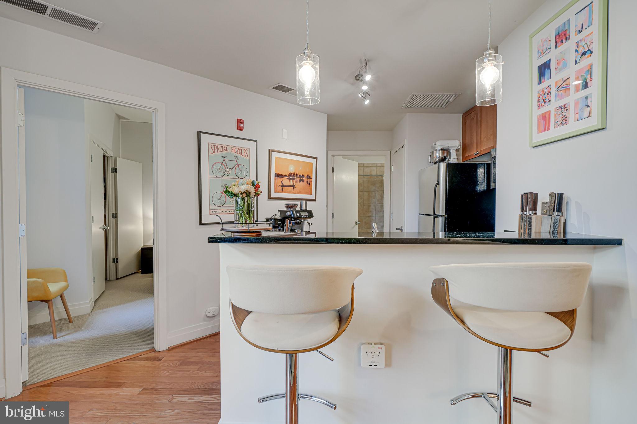 2120 Vermont Avenue Northwest, Unit 16 Washington, DC 20001 - Photo 5 of 21 a kitchen with stainless steel appliances granite countertop a sink and a refrigerator
