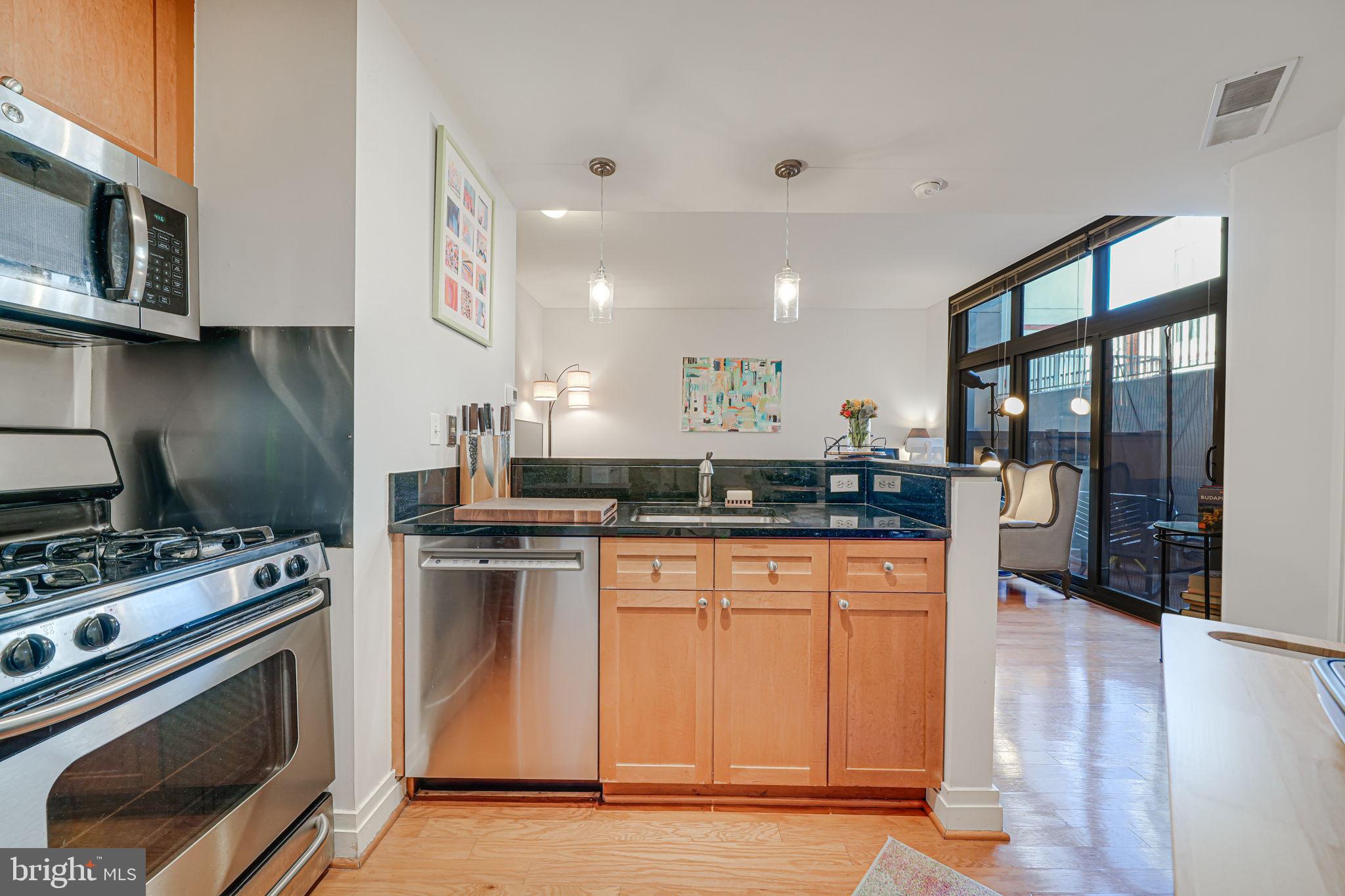 2120 Vermont Avenue Northwest, Unit 16 Washington, DC 20001 - Photo 8 of 21 a kitchen with stainless steel appliances a stove a sink and a microwave