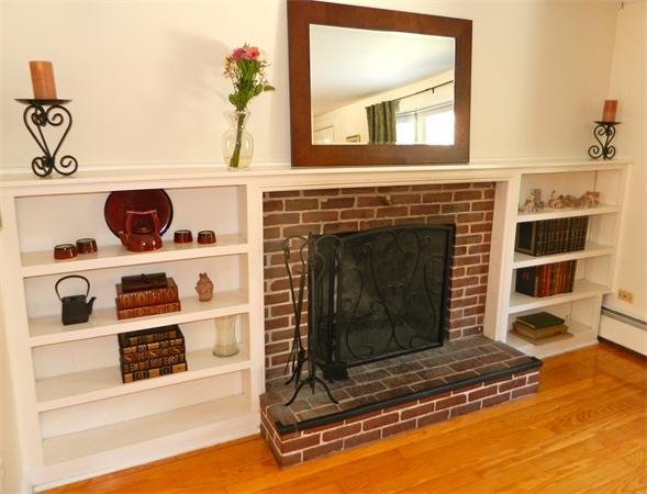 344 Hudson Road Stow, MA 01775 - Photo 8 of 28 a living room with a fireplace and a flat screen tv
