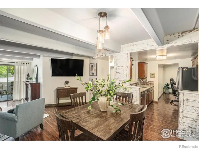 a living room with furniture dining table and a flat screen tv