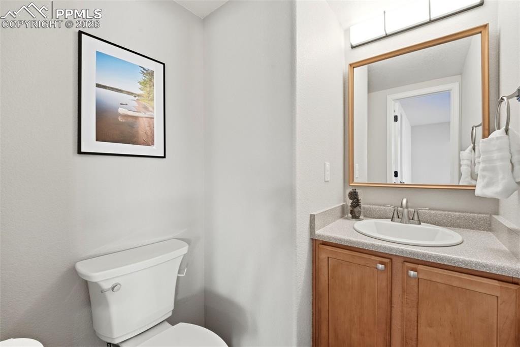 8318 Shadow Run Lane Fountain, CO 80817 - Photo 15 of 50 a bathroom with a toilet a sink and mirror