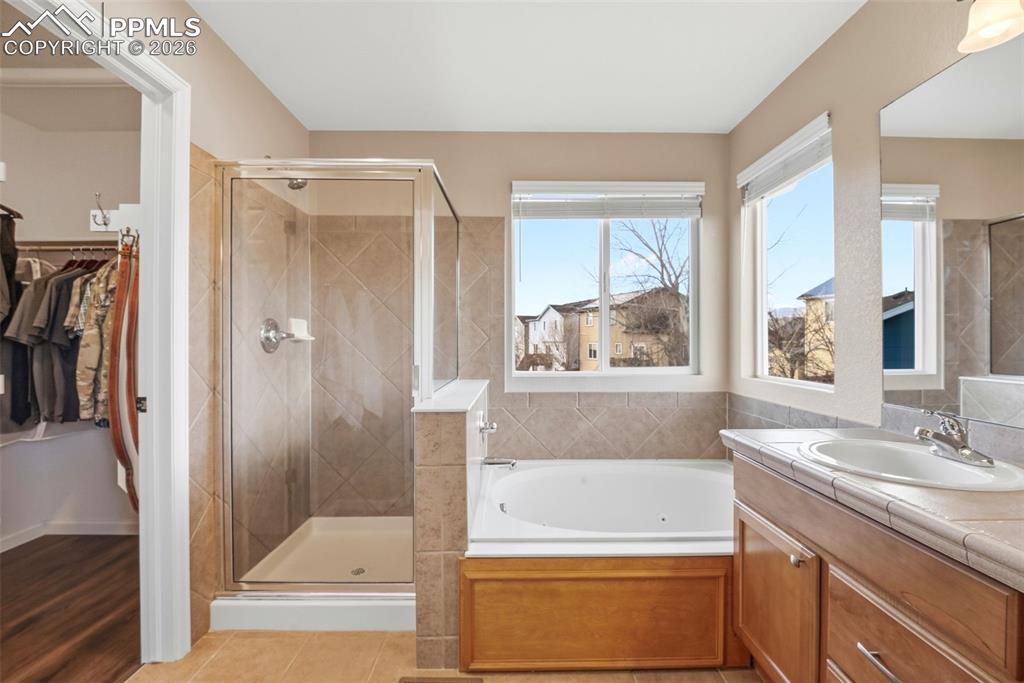 8318 Shadow Run Lane Fountain, CO 80817 - Photo 25 of 50 a bathroom with a tub sink and mirror