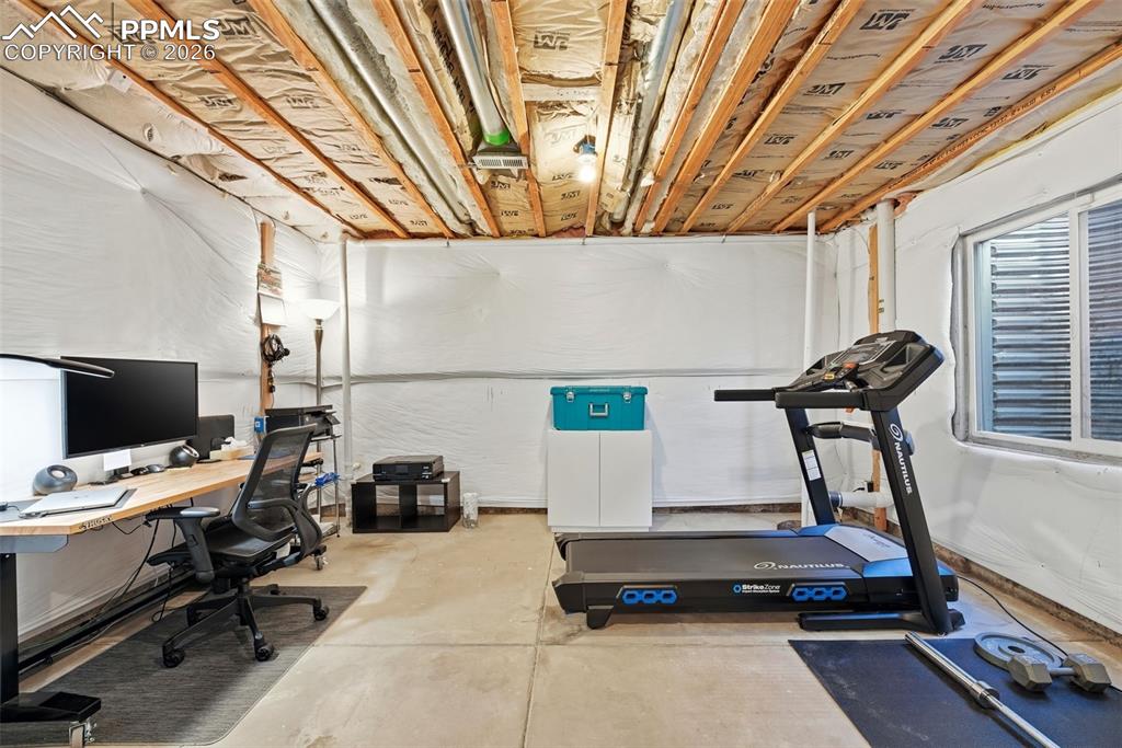 8318 Shadow Run Lane Fountain, CO 80817 - Photo 31 of 50 a room with gym equipment and a flat screen tv