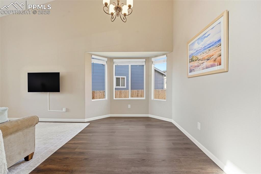 8318 Shadow Run Lane Fountain, CO 80817 - Photo 9 of 50 a view of an empty room with wooden floor and a window