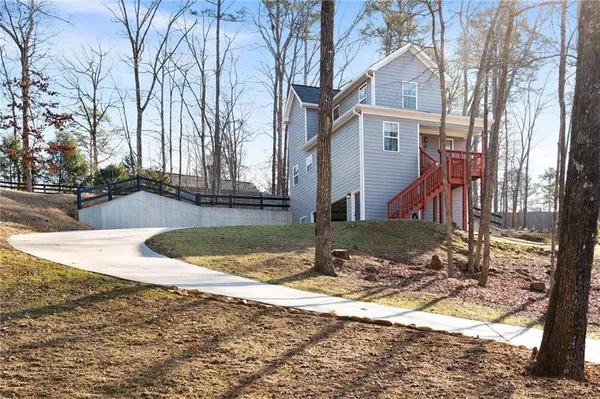 a view of a house with a yard covered in snow