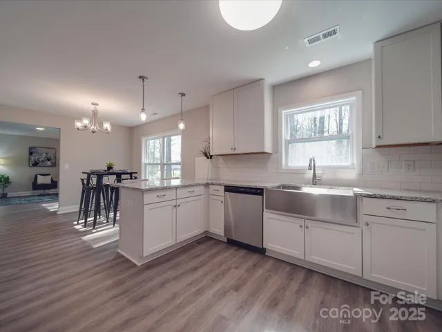 a kitchen with a sink cabinets and wooden floor