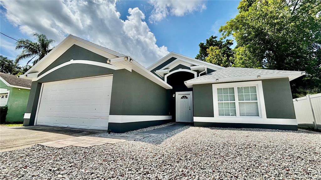712 19th Street Orlando, FL 32805 - Photo 1 of 28 a front view of a house with a yard and garage