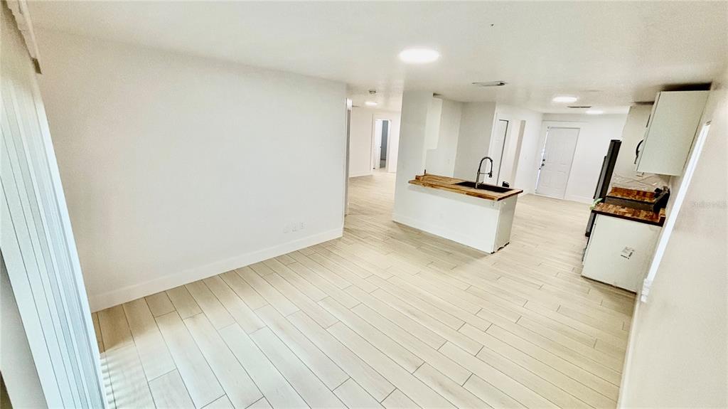 712 19th Street Orlando, FL 32805 - Photo 11 of 28 a view of a living room with kitchen furniture and a wooden floor