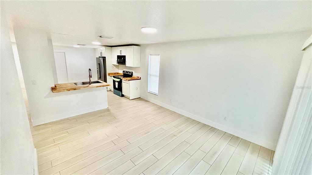 712 19th Street Orlando, FL 32805 - Photo 12 of 28 a view of a kitchen with furniture and wooden floor
